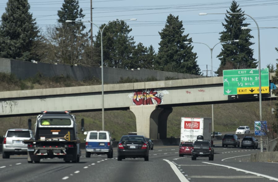 Graffiti is visible on the railroad crossing just south of Exit 4 on Interstate 5 in Vancouver on Monday. Washington Department of Transportation crews have increased their cleanup work this year, dealing with graffiti in 137 locations since January.