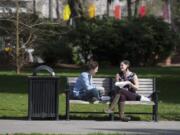 Cousins Shanley Carlton of Michigan, left, and Shannon Carlton of Vancouver take in some sunshine on March 12, 2018, while enjoying lunch at Esther Short Park in downtown Vancouver.