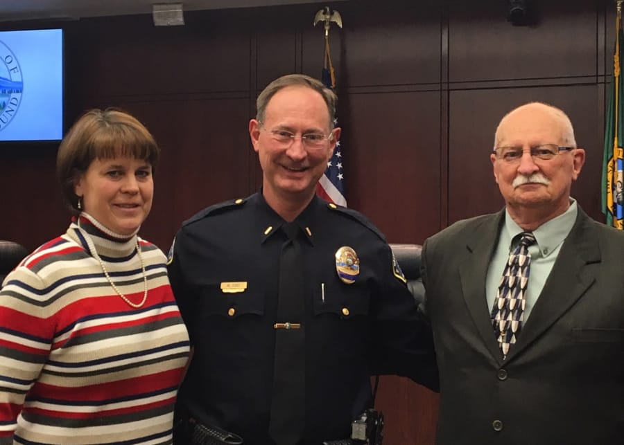 New Battle Ground police Lt. Mike Fort, formerly of the Portland Police Bureau, at his March 5 swearing-in ceremony, joined by his wife, Lisa, and father, George.