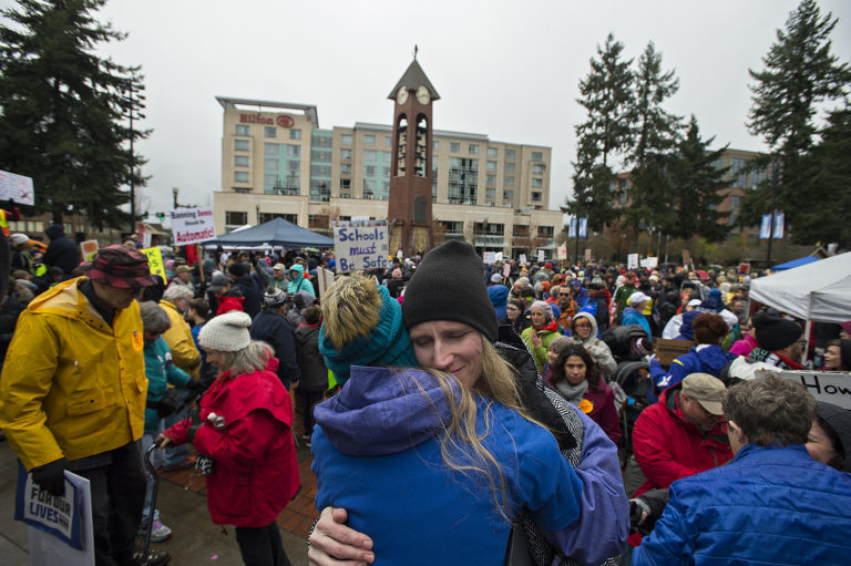 Heather Freitag of Vancouver, facing, embraces her daughter, Matthea Freitag, 12, after the March For Our Lives rally at Esther Short Park on Saturday afternoon. Matthea Freitag, who was one of the students that spoke to crowd, shared what it was like to have to live with the threat of a shooting at her school. Around 1,000 people came out to the event, which was one of dozens around the country organized by students in the wake of the recent Parkland, Fla., school shooting.
