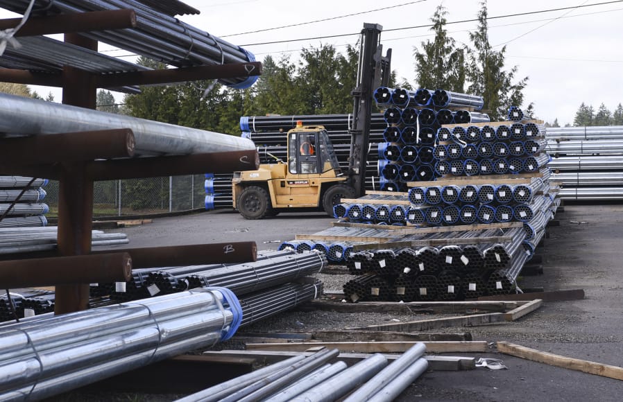 Jorge Sanchez, yard supervisor at State Pipe & Supply in Vancouver, moves bundles of steel pipe with a forklift Wednesday. Tariffs and new trade agreements could affect the supply of steel in Clark County, industry experts say.