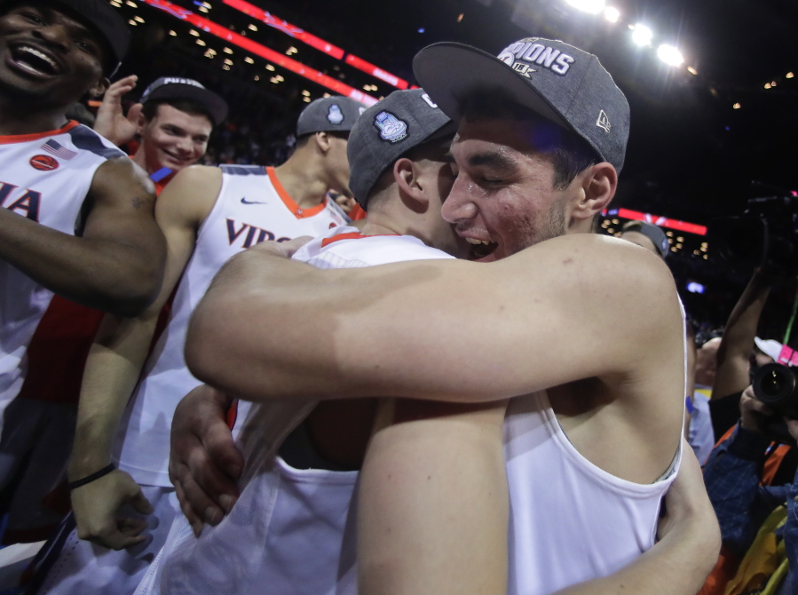 Virginia guard Ty Jerome, right, hugs guard Kyle Guy after Virginia defeated North Carolina 71-63 during an NCAA college basketball game for the Atlantic Coast Conference men’s tournament title Saturday, March 10, 2018, in New York.