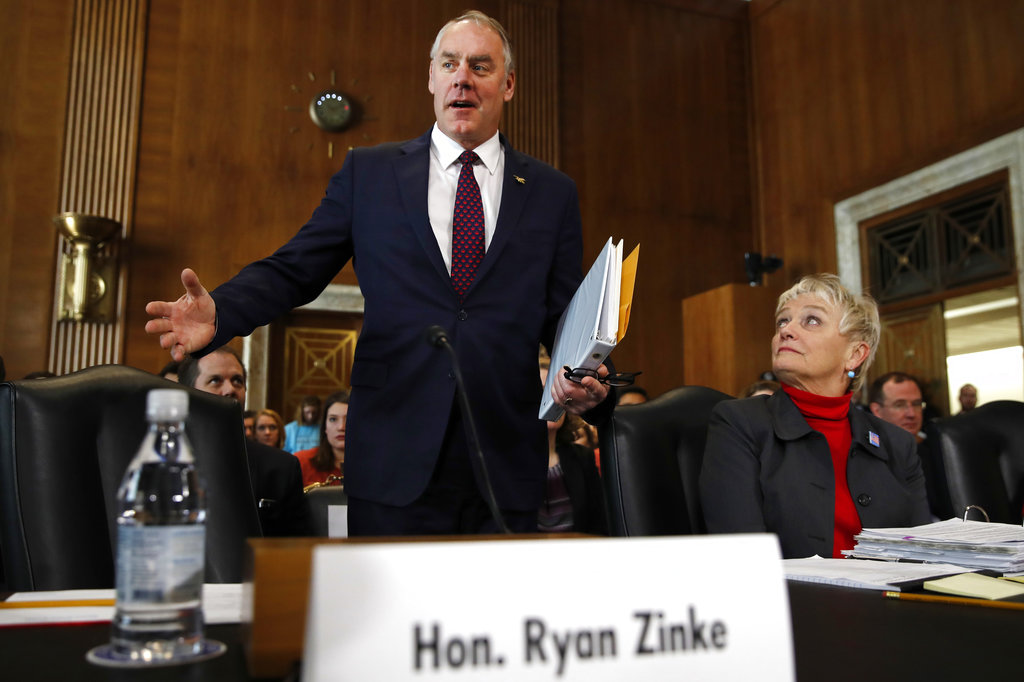 Interior Secretary Ryan Zinke arrives to testify before the Senate Committee on Energy and Natural Resources at a committee hearing on the President's Budget Request for Fiscal Year 2019, Tuesday, March 13, 2018, on Capitol Hill in Washington. At right is Olivia Barton Ferriter, with the Interior Department.