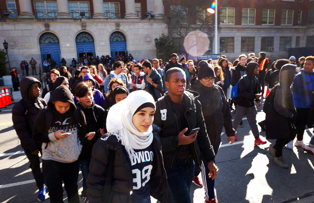 Hundreds of students walk out of Midwood High School as part of a nationwide protest against gun violence, Wednesday, March 14, 2018, in the Brooklyn borough of New York. It is the nation's biggest demonstration yet of the student activism that has emerged in response to last month's massacre of 17 people at Florida's Marjory Stoneman Douglas High School.