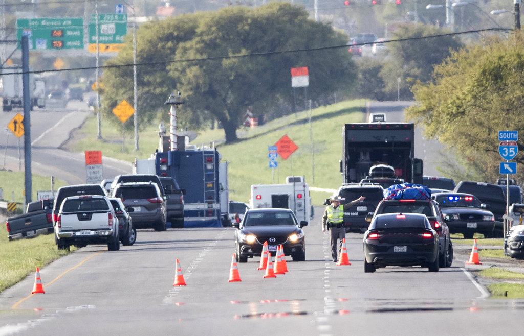 Officials work at a blocked off area near where a suspect in a series of bombing attacks in Austin blew himself up as authorities closed in, Wednesday, March 21, 2018, in Round Rock, Texas. (Ricardo B.