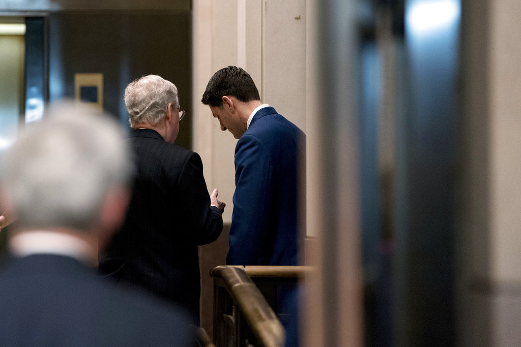 Senate Majority Leader Mitch McConnell of Ky., left, speaks with House Speaker Paul Ryan of Wis., right, behind closed doors following a Congressional Gold Medal Ceremony honoring the Office of Strategic Services in Emancipation Hall on Capitol Hill in Washington, Wednesday, March 21, 2018.