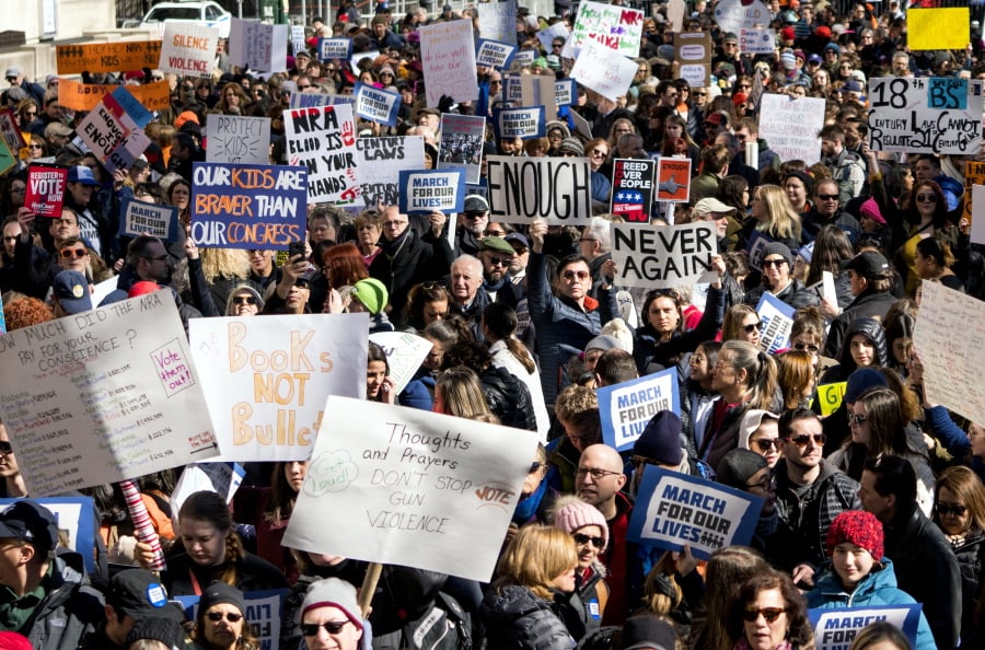 People take part in a march rally against gun violence Saturday, March 24, 2018, in New York. Tens of thousands of people poured into the nation's capital and cities across America on Saturday to march for gun control and ignite political activism among the young.