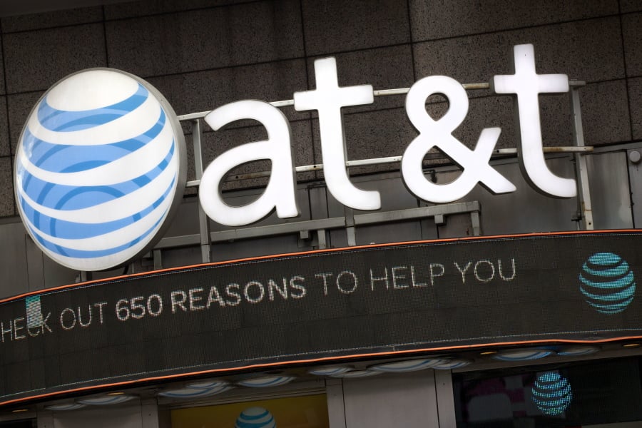 FILE - In this Oct. 24, 2016, file photo, the AT&T logo is positioned above one of its retail stores in New York. On Monday, March 19, 2018, AT&T squares off against the federal government in a trial that could shape how you get, and how much you pay, for streaming TV and movies. AT&T says it needs to gobble up Time Warner if it’s to have a chance against the likes of Amazon, Netflix and Google in the rapidly evolving world of video entertainment.