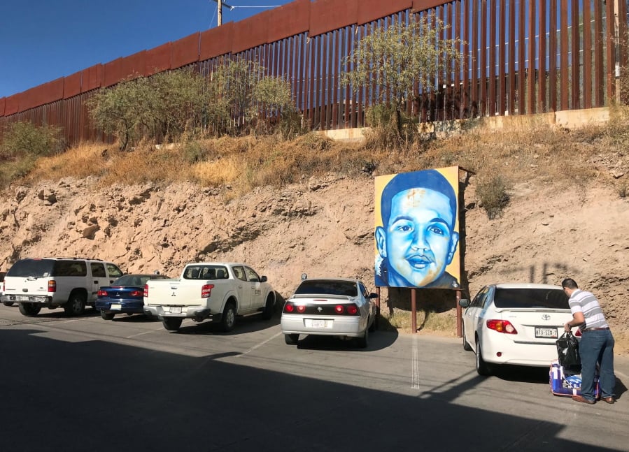 A portrait of 16-year-old Mexican youth Jose Antonio Elena Rodriguez, who was shot and killed in Nogales, Sonora, Mexico, is displayed on the street where he was killed that runs parallel with the U.S. border. A U.S. border patrol agent is going on trial for second-degree murder in U.S. District Court in Tucson on Tuesday, March 20, 2018, in a rare Justice Department prosecution of a fatal cross-border Mexico shooting. Lonnie Swartz is charged with firing multiple shots from the Arizona side of the border into Nogales, Mexico more than five years ago and killing Rodriguez.