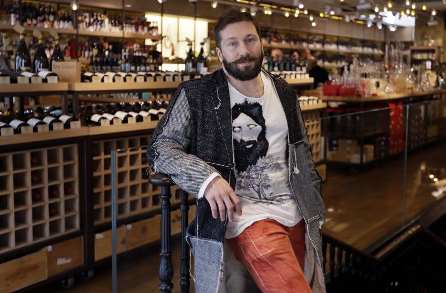 Russian entrepreneur Yevgeny Chichvarkin poses for a photograph in his wine shop Hedonism, in London. Amid the rising diplomatic tensions, some Russians feel they themselves trapped between stereotypes and political outrage. Chichvarkin, a one-time mobile phone entrepreneur and Kremlin critic who has lived in London for a decade, says he feels a bit less welcome. Even though he runs a an exclusive wine shop in the tony Mayfair district, plans for a new project that will create 200 jobs and contributes to art and society, his neighbors recently rejected his offer to install a trampoline in the local park.