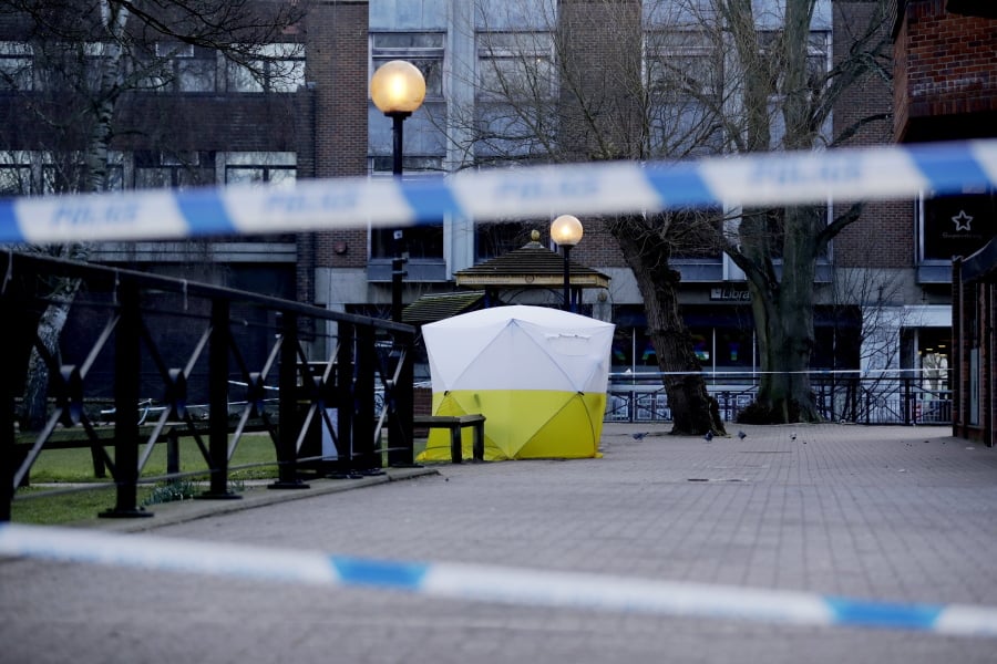 A police tent is framed by police tape Wednesday covering the spot where Sergei Skripal and his daughter were found critically ill in Salisbury, England.