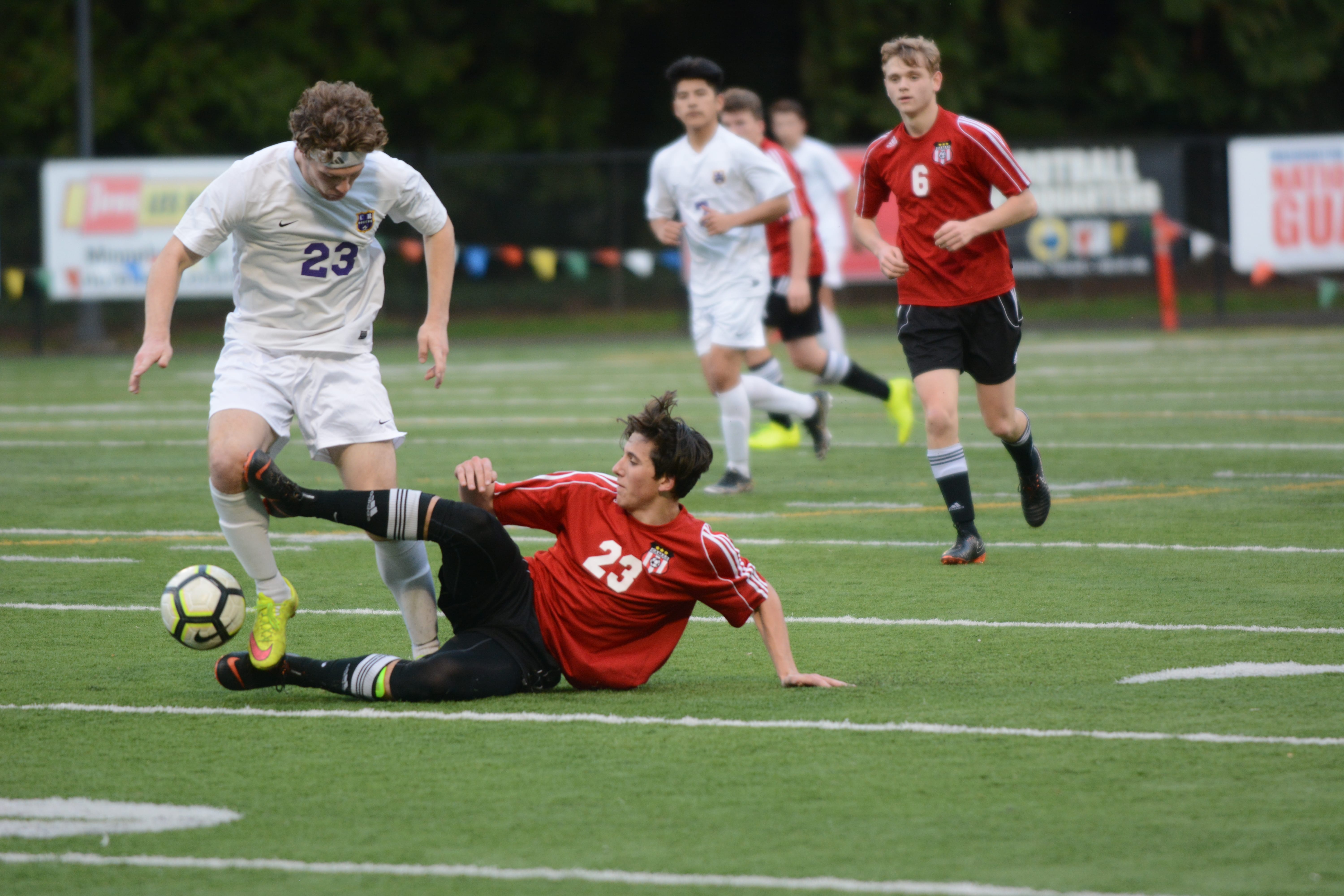 Camas freshman defender Gaven Myers pokes the ball free from Columbia River forward Ryan Connop in the first half of the Chieftains' 2-0 win over Camas on Saturday, March 10, 2018 at Kiggins Bowl (Andy Buhler/Columbian staff).