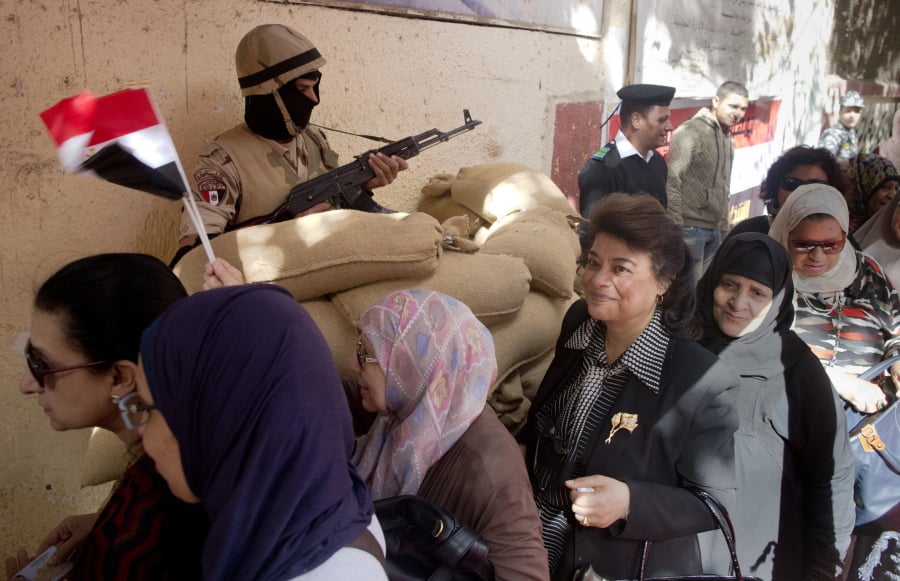 Women line up to enter a polling station during the first day of the presidential election in Cairo, Egypt, on Monday. Egyptians head to the polls on Monday but the presidential election this time is not about who wins — that was settled long ago — but about how many people bother to cast ballots.