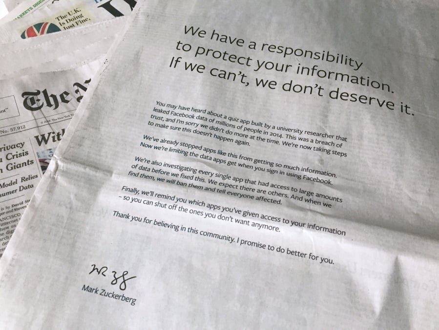An advertisement in The New York Times is displayed on Sunday in New York. Facebook’s CEO apologized for the Cambridge Analytica scandal with ads in multiple U.S. and British newspapers Sunday. The ads signed by Mark Zuckerberg say the social media platform doesn’t deserve to hold personal information if it can’t protect it.