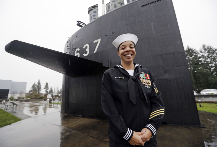 U.S. Navy YN1 Suraya Mattocks, one of the first female enlisted sailors to be selected to serve on submarines, stands Jan. 18 in front of a submarine sail at the U.S. Naval Undersea Museum near her base in Keyport.