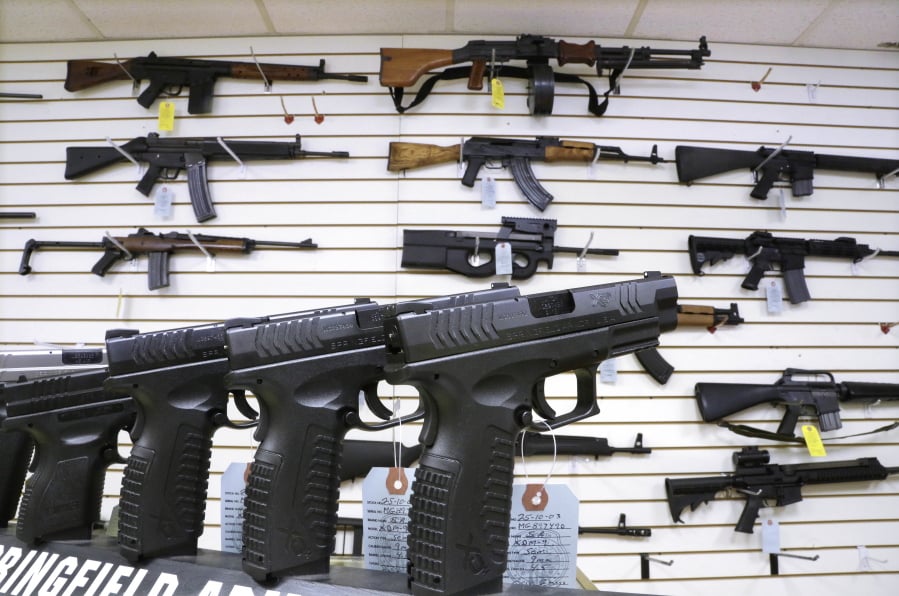 Assault weapons and hand guns are seen for sale at Capitol City Arms Supply in Springfield, Ill., in 2013.