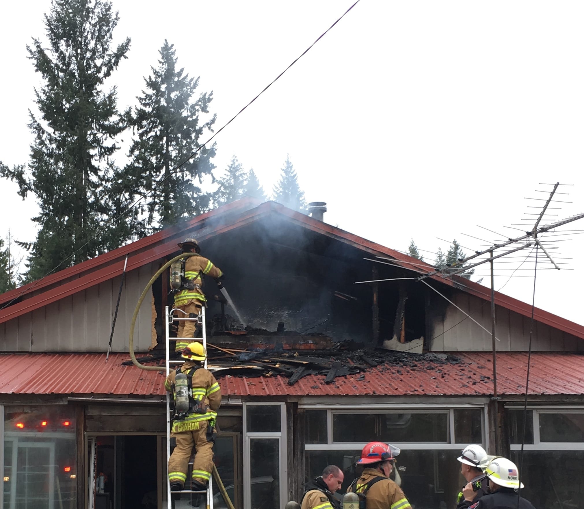 Firefighters work to quell the flames from a house fire north of Ridgefield Wednesday afternoon. No one was seriously hurt.