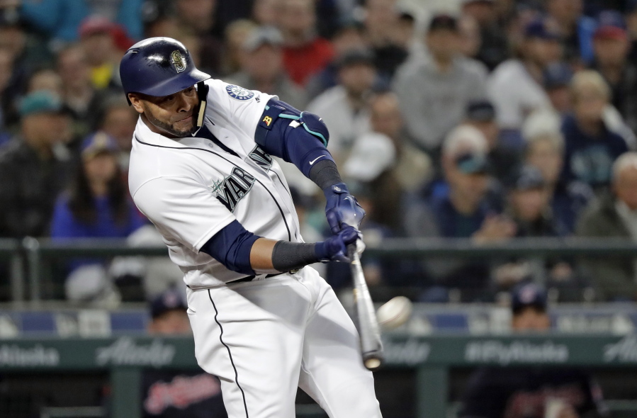Seattle Mariners' Nelson Cruz connects for a two-run home run against the Cleveland Indians during the first inning of a baseball game Thursday, March 29, 2018, in Seattle.