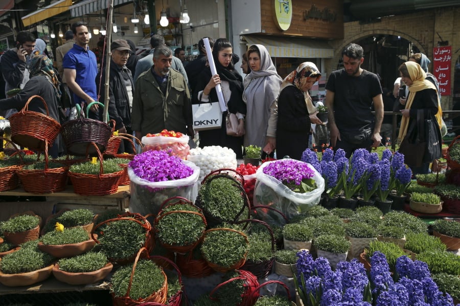 Iranians shop for hyacinths, garlic, sprouts and other items used to celebrate the Iranian New Year on Monday in Tehran, Iran.