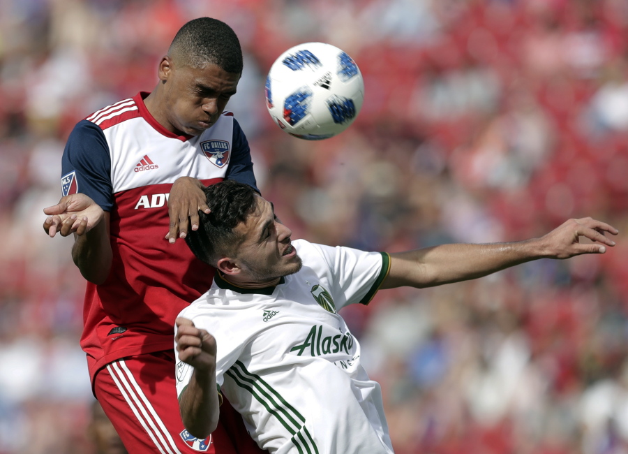FC Dallas defender Reggie Cannon (2) and Portland Timbers midfielder Cristhian Paredes, right, compete for a loose ball in the second half of an MLS soccer match in Frisco, Texas, Saturday, March 24, 2018.