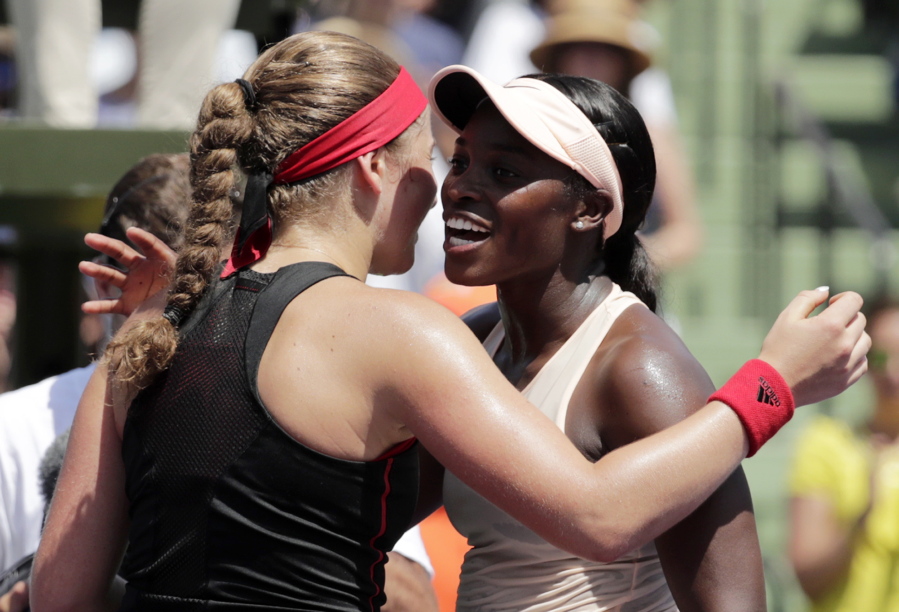 Jelena Ostapenko, left, of Latvia, hugs Sloane Stephens at the net after the final at the Miami Open tennis tournament, Saturday, March 31, 2018, in Key Biscayne, Fla. Stephens won 7-6 (5), 6-1.
