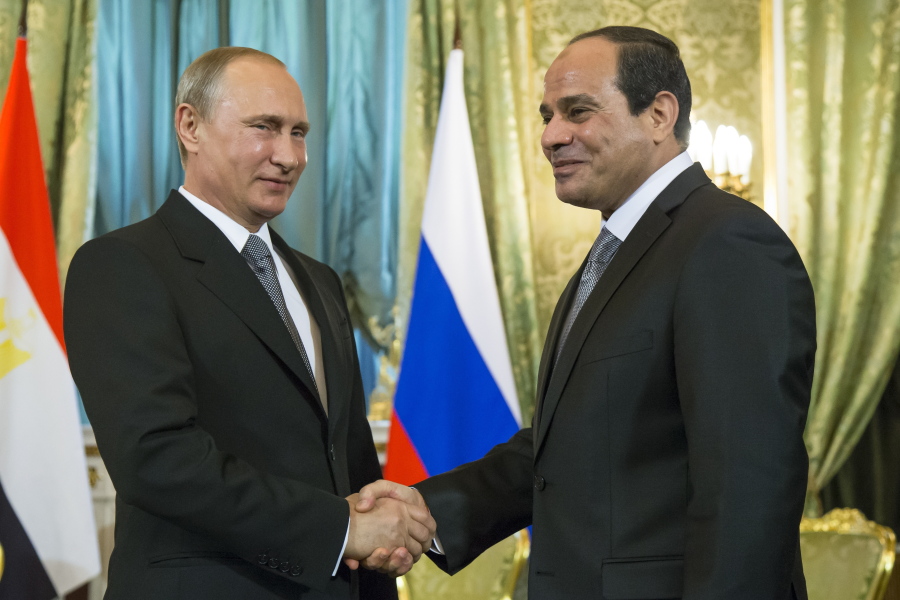 Russian President Vladimir Putin, left, shakes hands with Egyptian President Abdel-Fattah el-Sissi during their meeting in the Kremlin, Moscow, Russia. Egyptians go to the polls next week in what is essentially a one-candidate election -- but almost nowhere has democracy taken hold in the Arab world. While the democratic record is dismal, the Middle East is hardly alone in what seems to be a global trend away from liberal democracy.