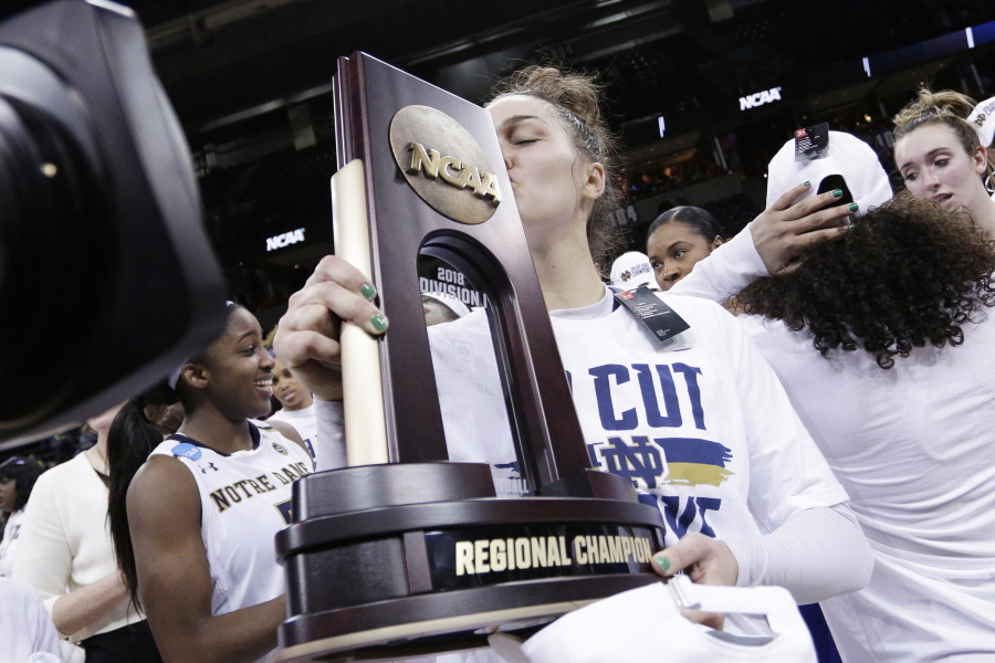 Notre Dame forward Kathryn Westbeld kisses the tournament trophy after defeating Oregon 84-74 in a regional final at the NCAA women’s college basketball tournament, Monday, March 26, 2018, Spokane, Wash.