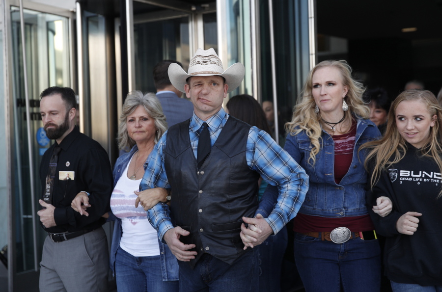 FILE - In this Dec. 20, 2017, file photo, from left, Ryan Payne, Jeanette Finicum, widow of Robert “LaVoy” Finicum, Ryan Bundy, Angela Bundy, wife of Ryan Bundy and Jamie Bundy, daughter of Ryan Bundy, walk out of a federal courthouse in Las Vegas. Ryan Bundy, the eldest son of the Nevada rancher at the center of an armed standoff with federal agents in 2014, says, Thursday, March 8, 2018, he’ll mount an independent campaign for governor as a states’ rights fundamentalist.