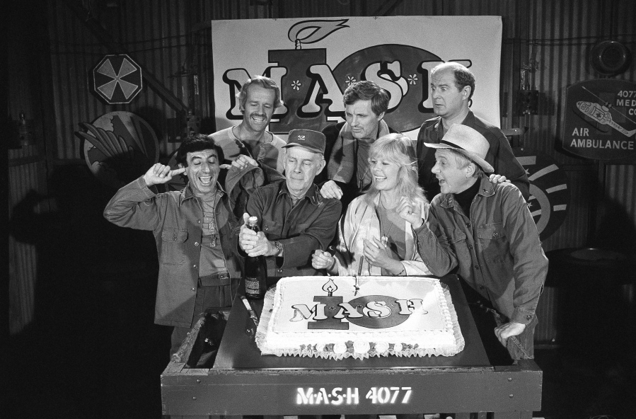 FILE - In this Oct. 22, 1981, file photo, Jamie Farr, from front left, plugs his ears as cast members of the "M.A.S.H." television series cast Harry Morgan, Loretta Swit, William Christopher and, from back from left, Mike Farrell, Alan Alda and David Ogden Stiers celebrate during a party on the set of the popular CBS program in Los Angeles. Stiers a prolific actor best known for playing a surgeon on the television series "M.A.S.H." has died, the actor's agent Mitchell Stubbs confirmed Saturday night, March 4, 2018, in an email. He was 75.