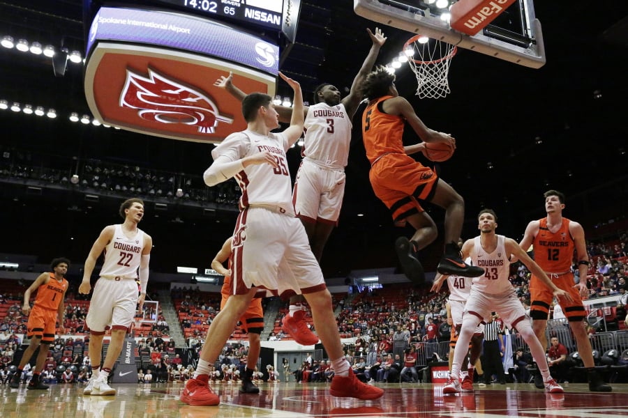 Oregon State guard Ethan Thompson (5) shoots next to Washington State forward Robert Franks (3) during the second half of an NCAA college basketball game in Pullman, Wash., Saturday, March 3, 2018.