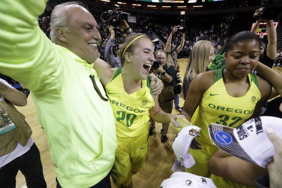 Oregon’s Sabrina Ionescu (20) celebrates with her dad, Dan Ionescu, after the team beat Stanford in an NCAA college basketball game in the finals of the Pac-12 Conference women’s tournament, Sunday, March 4, 2018, in Seattle. Oregon won 77-57.