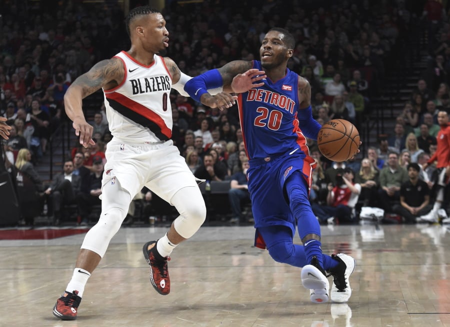 Detroit Pistons guard Dwight Buycks tries to get past Portland Trail Blazers guard Damian Lillard during the first half of an NBA basketball game in Portland, Ore., Saturday, March 17, 2018.