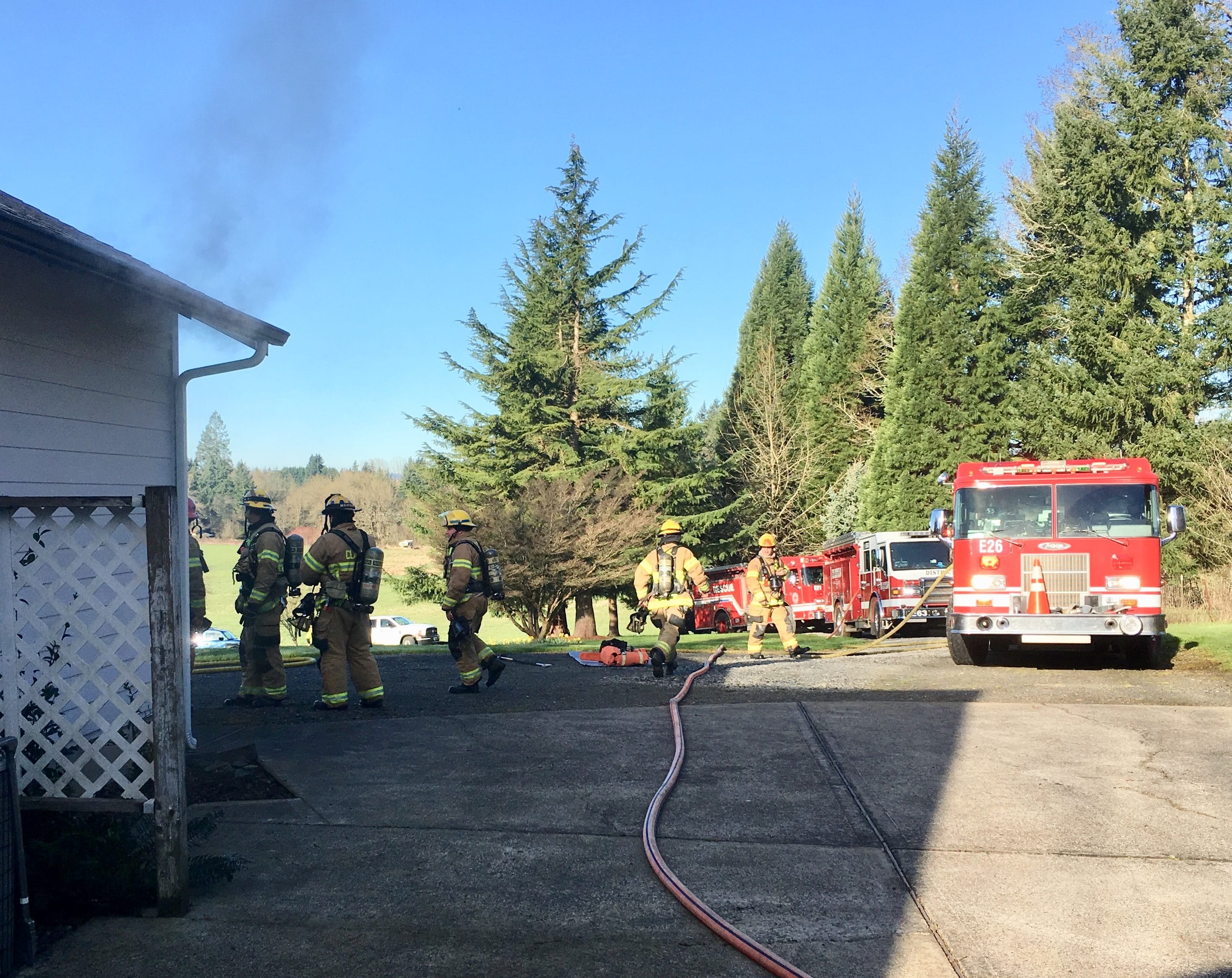 Firefighters work at the scene of a Ridgefield house fire Tuesday morning. The Clark County Fire Marshal is investigating the cause.