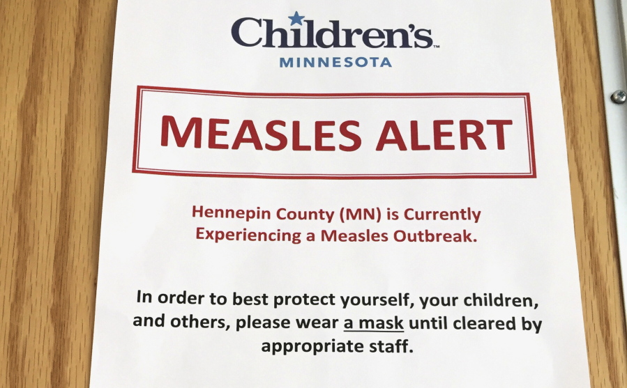 A sign at the specialty clinic at Children’s Minnesota in Minneapolis alerts patients to a measles outbreak in 2017.