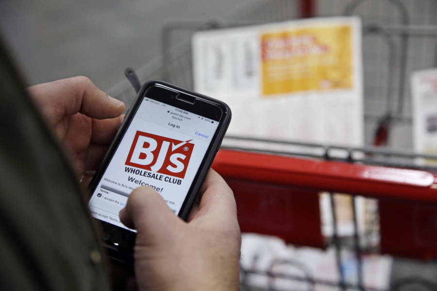 Tony D’Angelo logs into the store’s Wi-Fi to download the BJ’s Express Scan app on his cellphone before beginning his shopping at the BJ’s Wholesale Club in Northborough, Mass.