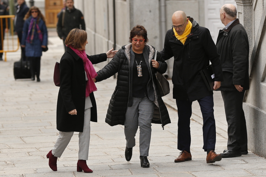 Former Catalan Parliament Speaker Carme Forcadell, left, separatist politician Dolors Bassa, center and former Cabinet member Raul Romeva arrive at the Supreme Court in Madrid, Friday, March 23, 2018. A Spanish Supreme Court probe into last year’s attempt to secede Catalonia from Spain wraps Friday with the judge issuing indictments and possible rebellion and other charges for various regional politicians and separatist leaders and signaling that he may issue for the latter preventive measures that could include pre-trial jailing.