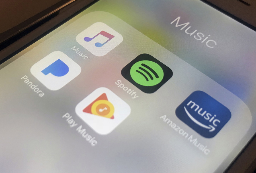 ADDS TO CLARIFY SPOTIFY IS NOT RAISING MONEY - FILE - This Jan. 28, 2018, file photo shows music streaming apps clockwise from top left, Apple, Spotify, Amazon, Pandora and Google on an iPhone in New York. Music-streaming pioneer Spotify plans an initial public offering of stock. The first steps toward IPO were made in a confidential filing a few weeks ago, but the documents weren’t released until Wednesday, Feb. 28.