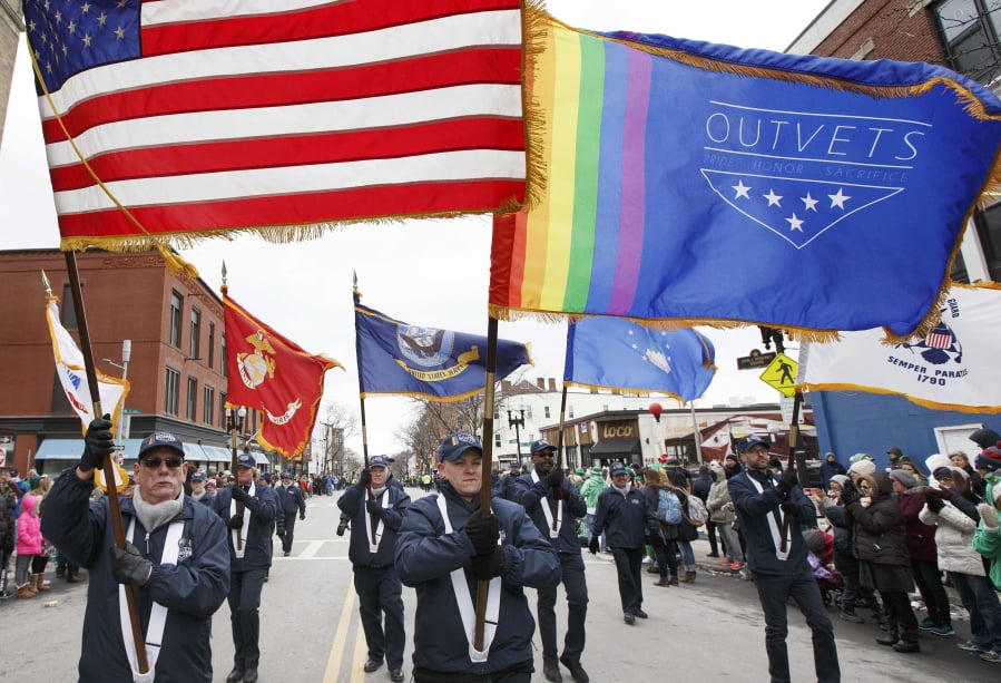 FILE - In this March 19, 2017 file photo, a group from OutVets marches in the annual St. Patrick’s Day parade in Boston. The council that runs the parade drew furor for banning gay veterans before relenting in 2014. Parade organizers say new leadership of the South Boston Allied War Veterans Council, which runs the annual event, marks the beginning of a new era of inclusion. But it has refused to accommodate Veterans for Peace, and the anti-war group won’t be allowed to walk in the parade on Sunday, March 18, 2018.