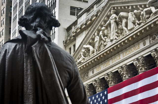 Federal Hall's George Washington statue stands near the flag-covered pillars of the New York Stock Exchange. The U.S. stock market opened at 9:30 a.m. EDT on Friday, March 23, 2018.
