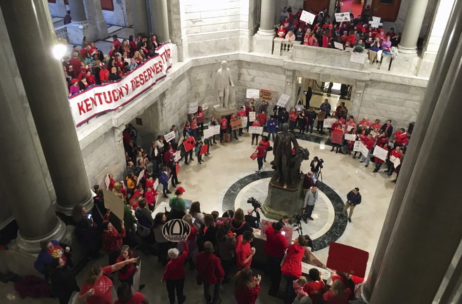 Hundreds of Kentucky teachers protest outside of Gov. Matt Bevin’s office on Friday, March 30, 2018, in Frankfort, Ky. State lawmakers passed a bill late Thursday night that makes changes to the state’s pension system. Bevin could sign the bill into law on Friday.