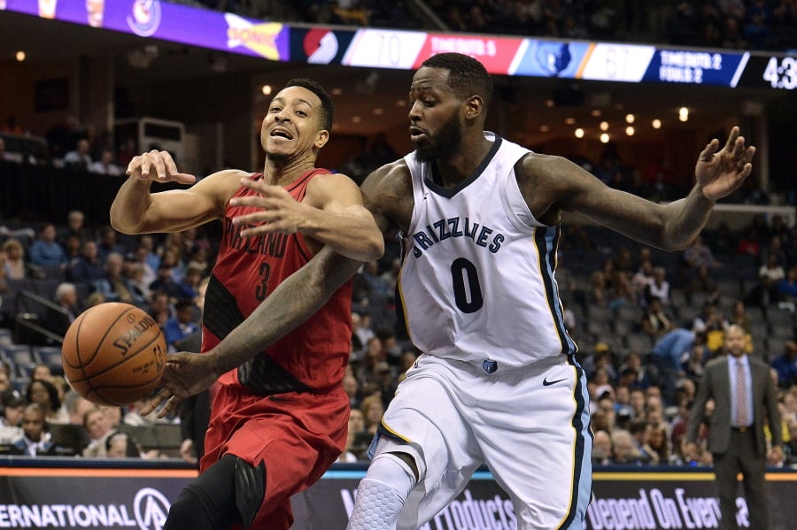 Memphis Grizzlies forward JaMychal Green (0) knocks the ball loose from Portland Trail Blazers guard CJ McCollum (3) in the second half of an NBA basketball game Wednesday, March 28, 2018, in Memphis, Tenn.