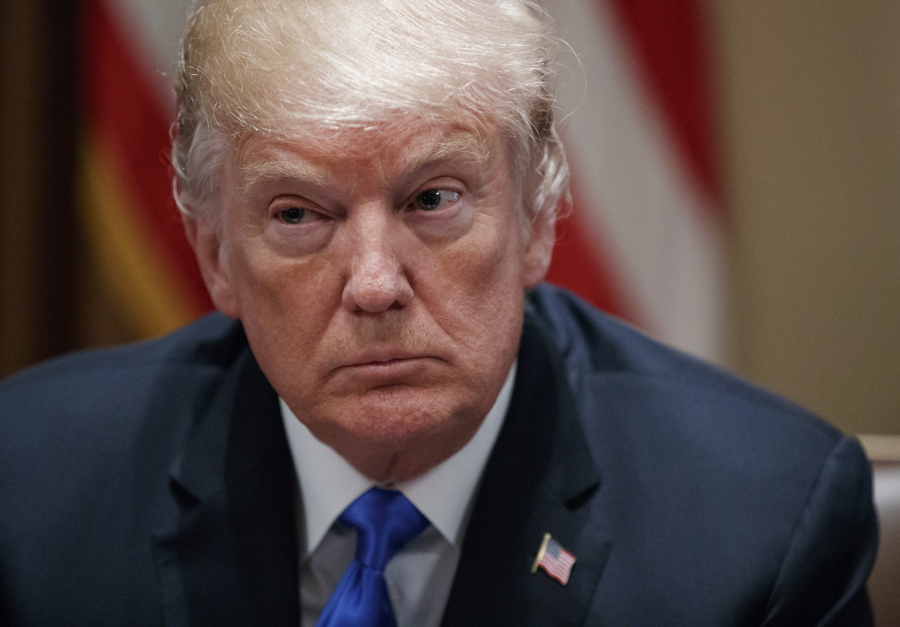 President Donald Trump pauses during a meeting in the Cabinet Room of the White House, in Washington, with members of congress to discuss school and community safety.