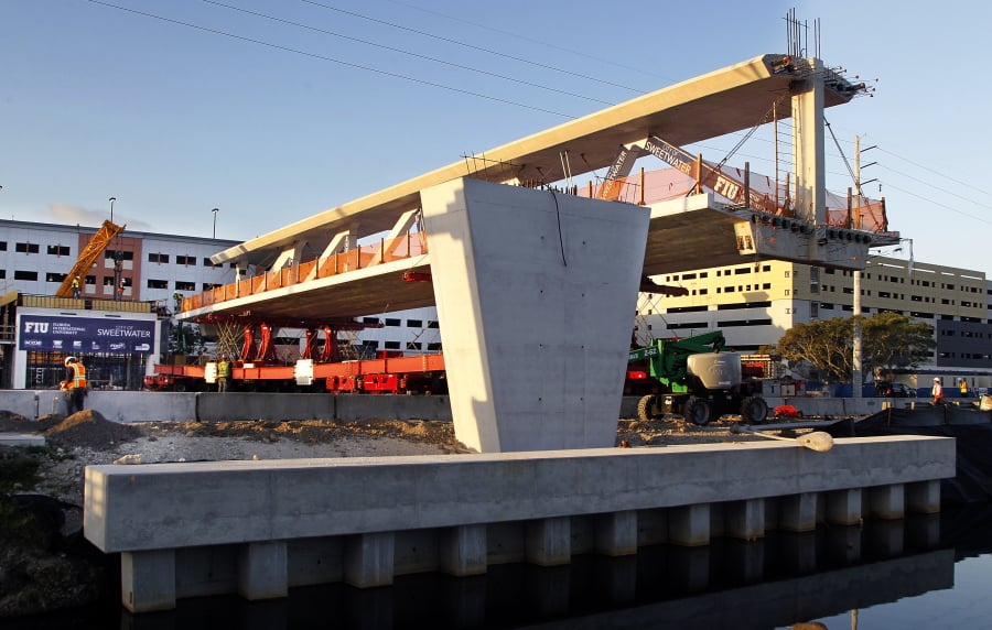 this March 10, 2018 photo shows an early morning view of the main span of the a pedestrian bridge that is being positioned to connect the City of Sweetwater, Fla., to Florida International University near Miami. The 950- ton new bridge collapsed, Thursday, March 15, over several cars causing several fatalities and injuries.