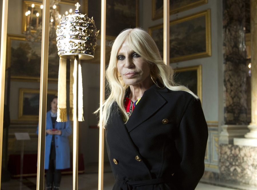 Donatella Versace poses next to one of the Tiara (1877) of pope Pius IX in Rome, Monday, Feb. 26, 2018. The Vatican is loaning some of its most beautiful liturgical vestments, jeweled miter caps and historic papal tiaras for an upcoming exhibit on Catholic influences in fashion at the Metropolitan Museum of Art. The Vatican culture minister, Cardinal Gianfranco Ravasi, joined Vogue Editor-in-Chief Anna Wintour and designer Donatella Versace in Rome on Monday to display a few of the Vatican treasures at the Palazzo Colonna, a onetime papal residence. “Heavenly Bodies: Fashion and the Catholic Imagination” is set to open May 10 at the Met’s Costume Institute in New York.