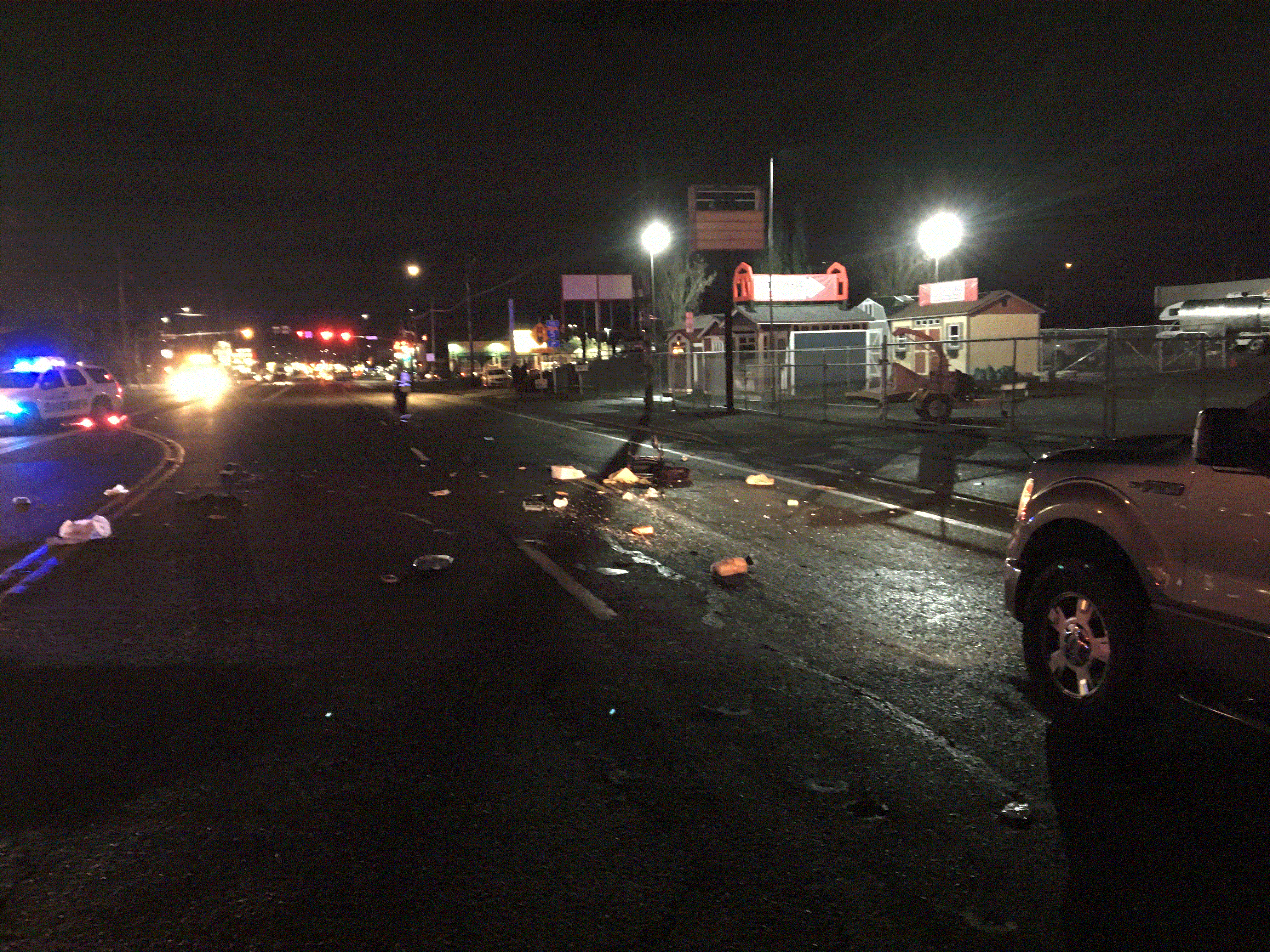 Wreckage marks the scene of a fatal crash involving a pickup and a pedestrian in the 8200 block of Northeast Highway 99 on Friday evening.