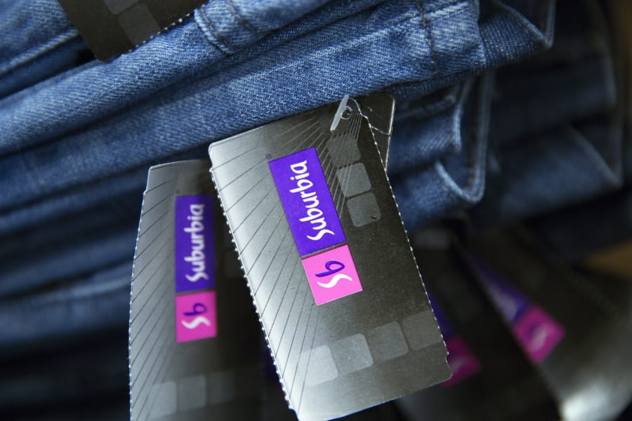 Tags hang from a pair of blue jeans at a Wal-Mart de Mexico Suburbia department store in Mexico City on Oct.17, 2014.