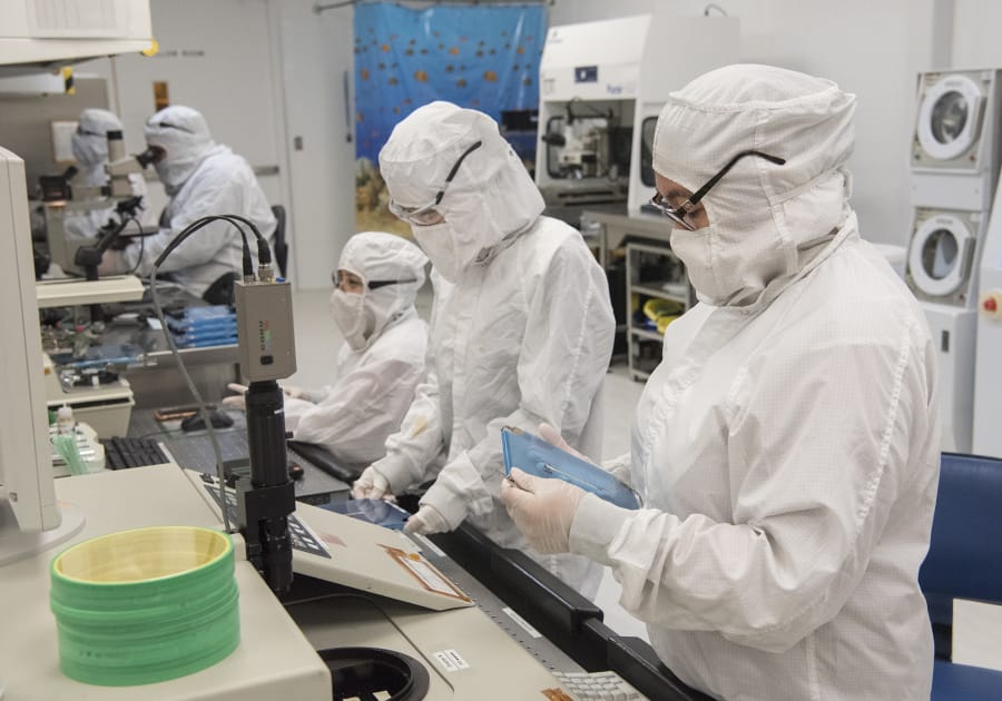 Technicians at nLight’s Vancouver offices in October process laser bars into chips that will eventually be used in lasers. NLight will soon go public, offering shares between $13 and $15.