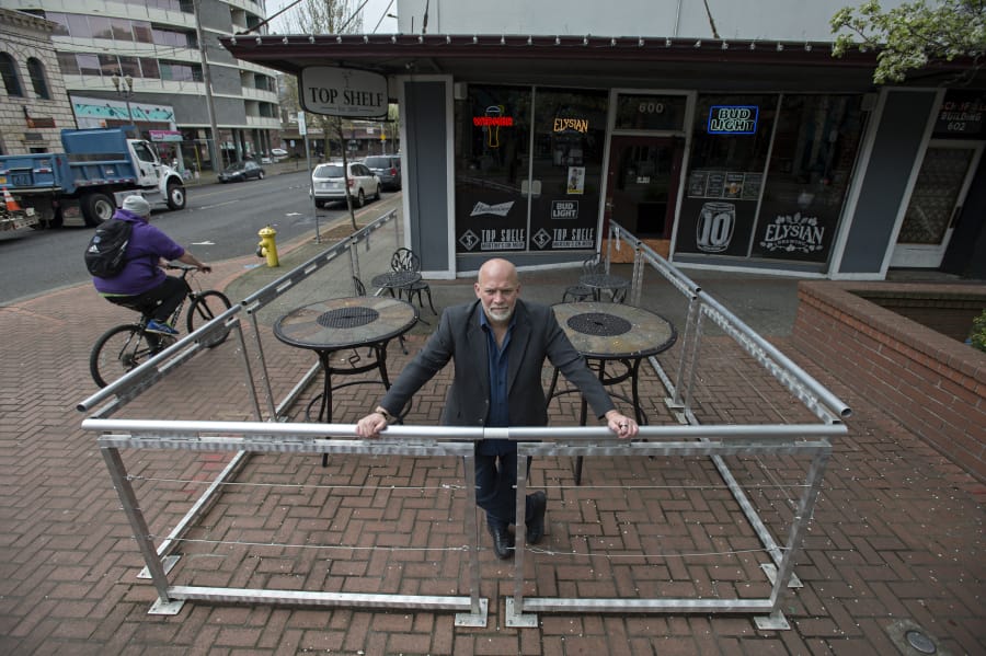 Daren Morgan, owner of Top Shelf Martinis on Main, pauses for a portrait in his outdoor patio space in downtown Vancouver. The city of Vancouver has told Morgan it won’t renew permits for the patio unless it is reconfigured.