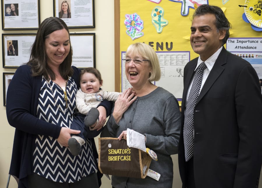 Kimberly Pincheira, left, holds her son Alexander, 6 months, left, as they pose for a photo with Sen. Patty Murray and author Ajay Chaudry at the Hough Early Learning Center in Vancouver on Wednesday morning. Chaudry wrote, “Cradle to Kindergarten: A New Plan to Combat Inequality,” and is joining Murray’s efforts to fight for affordable child care.