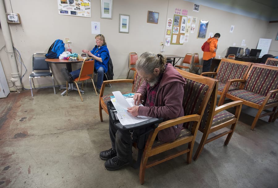 David La Buda works on paperwork at the day center at Friends of the Carpenter at 1600 W. 20th St. in Vancouver. La Buda is among several clients who plan to use a new day center planned for the former state Fish and Wildlife building at 2018 Grand Blvd. in Vancouver.